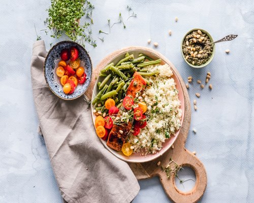 A healthy bowl of rice, beans, and fresh vegetables